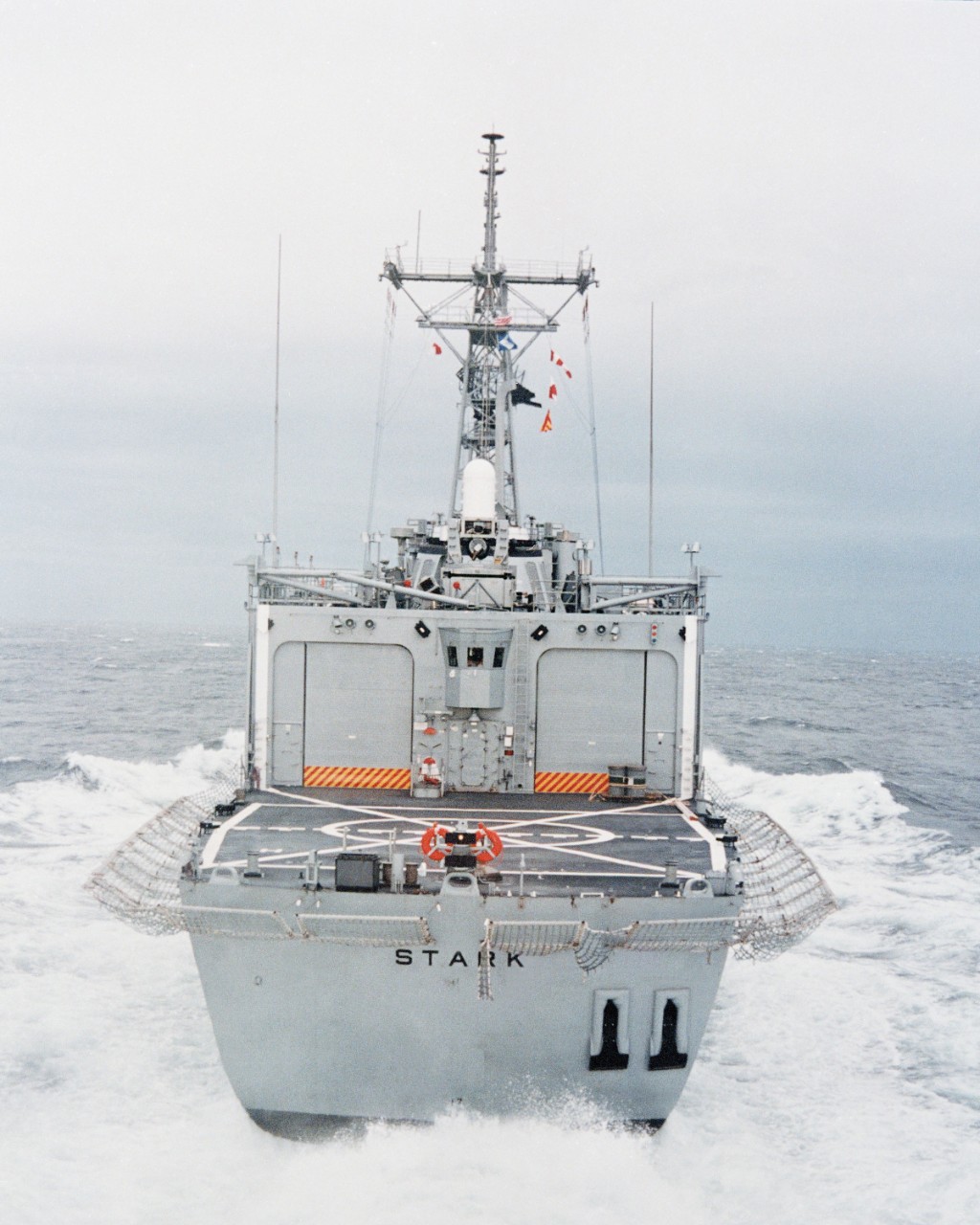 A stern shot of Stark shows the ship churning the water as she makes speed during the trials, 13 July 1982. Note the CIWS mount, and the hangars and flight deck. (Todd Pacific Shipyards Corp., Department of Defense Photograph DN-SC-83-11742, Stil...