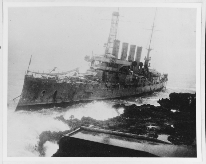 Memphis lies wrecked at Santo Domingo. This photograph was probably taken early on 30 August 1916, as the ship appears to be abandoned. Note the anchor chain running seaward from her starboard bow. (U.S. Navy Photograph NH 59921, Photographic Section, Naval History and Heritage Command)