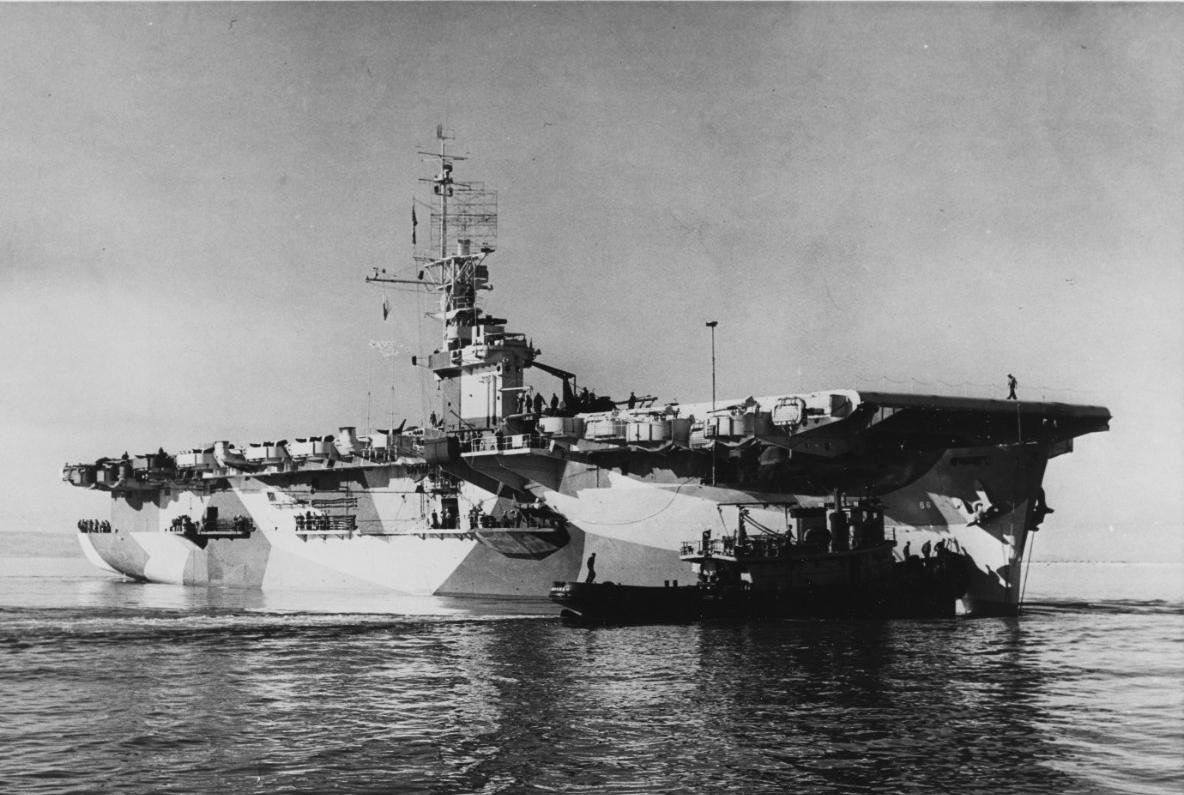Harbor tug Wenonah (YT-148) assists White Plains (CVE-66) in San Diego Harbor, Calif., circa April 1944. White Plains is painted in Camouflage Measure 33, Design 10A. (U.S. Navy Photograph 80-G-302258, National Archives and Records Administration...