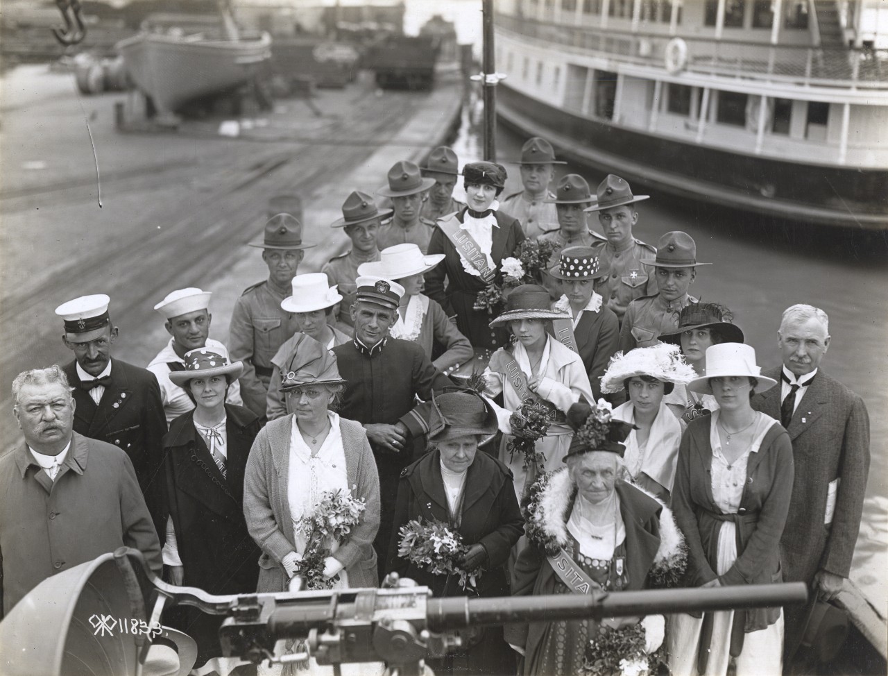 Those involved in the ceremonies honoring the dead of the Great War gather on Wicomico’s forecastle at the Washington Navy Yard, 30 May 1918, in this image captured by Lt. E. M. de Barri. Those present include Mrs. Mary Lockwood (Honorary Chaplai...