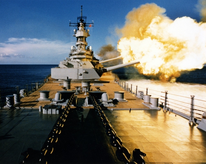 Wisconsin firing a broadside to port with her 16-inch/50 and 5-inch/38 guns, circa 1988-91. (Naval History and Heritage Command Photograph NH 97207-KN).