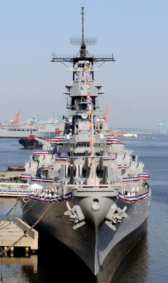 The decommissioned Wisconsin berthed at Nauticus during a ceremony officially transferring the battleship from the Navy to the city of Norfolk, 16 April 2010. The transfer ended the requirement for the ship to be preserved for possible recall to active duty. (Mass Communication Specialist Seaman Scott Pittman, U.S. Navy Photograph 100416-N-3154P-001, Navy.mil Photos).