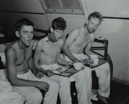 (L to R) Bernard B. Bateman, F2c USNR; A.C. King, S1c USNR; and Erick T. Anderson, S2c USNR, survivors of the USS Indianapolis in Naval Base Hospital No. 20, Peleliu, 5 August 1945. 