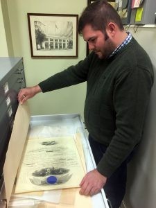 170410-N-FJ200-002 WASHINGTON (April 10, 2017) Naval History and Heritage Command Special Collections Reference Librarian Tim Bostic, examines a presidential citation letting while discussing the numerous holdings in the Navy Department Library. ...