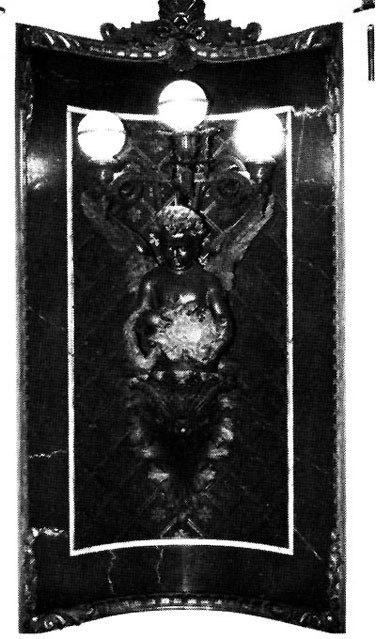 Figure 40: Arts and Sciences Lamp, Indian Treaty Room. This figure carries a wreath and cartouche decorated with maps of the two hemispheres.