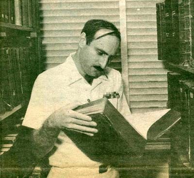 YNC Paul J. Heine, Assistant Administrative Personnel Officer for the Navy Department Band researches in an old volume of Lloyd's Register.