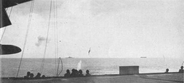 Image from deck showing suicide plane in background.