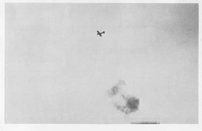 Japanese fighter plane ("Zeke") under 5" and machine-gun fire.