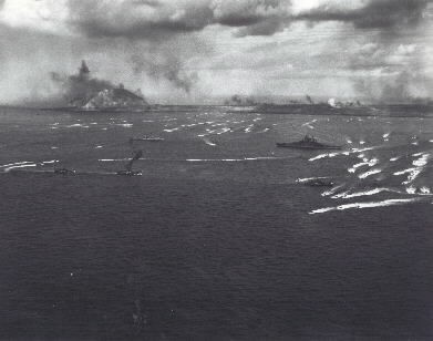 Iwo Jima Invasion, Feb. 1945: LVTs retracting from the Iwo Jima beaches after landing the initial waves of marines, in the morning of 19 February, 1945. USS Tennessee (BB-43) is in the right center. Photograph attributed to LtJG Gene Senier. NHHC...