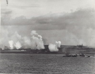 Iwo Jima Operation, 1945: White phosphorous rounds burst ashore as destroyers prepare for a underwater demolition team operation off Iwo Jima's West Beach at 4:00 P.M., 17 February 1945. Note "Fletcher" class destroyer firing at right. Photograph...