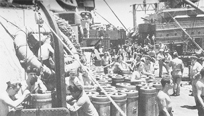 Image of ammunition ship Shasta loading 14-inch powder and shells onto the New Mexico.