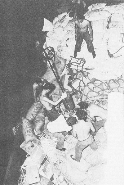 Image of men taking sugar on the carrier Lexington at night.