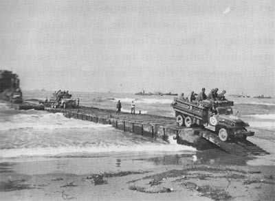 1006th Seabees in the Salerno Invasion Unloading an LST Over a Pontoon Causeway at Safta Beach. 