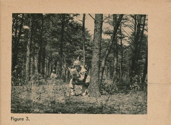 Figure 3: Soldier reading map in forest.