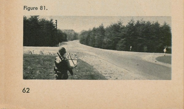 Figure 81: A man at an intersection holding a map.