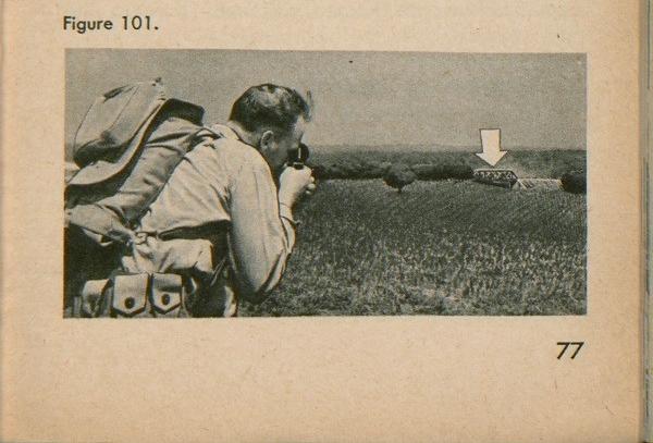 Figure 101: A soldier looking through a compass at a bridge.