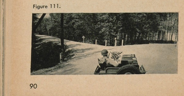 Figure 111: A soldier in a car at a fork in the road looking at a map.