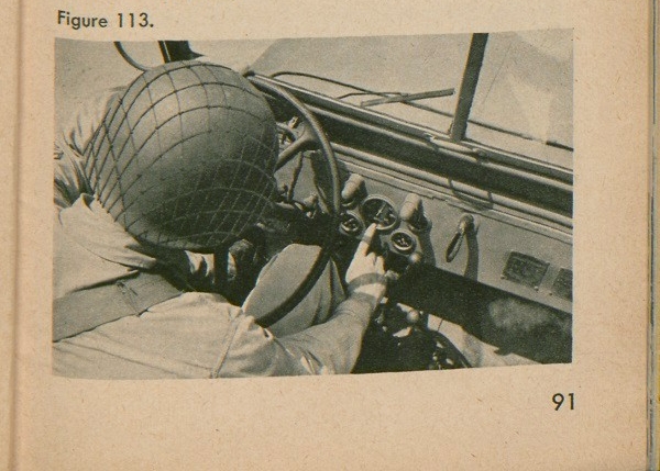 Figure 113: A soldier pointing at the mileage gauge in a jeep.