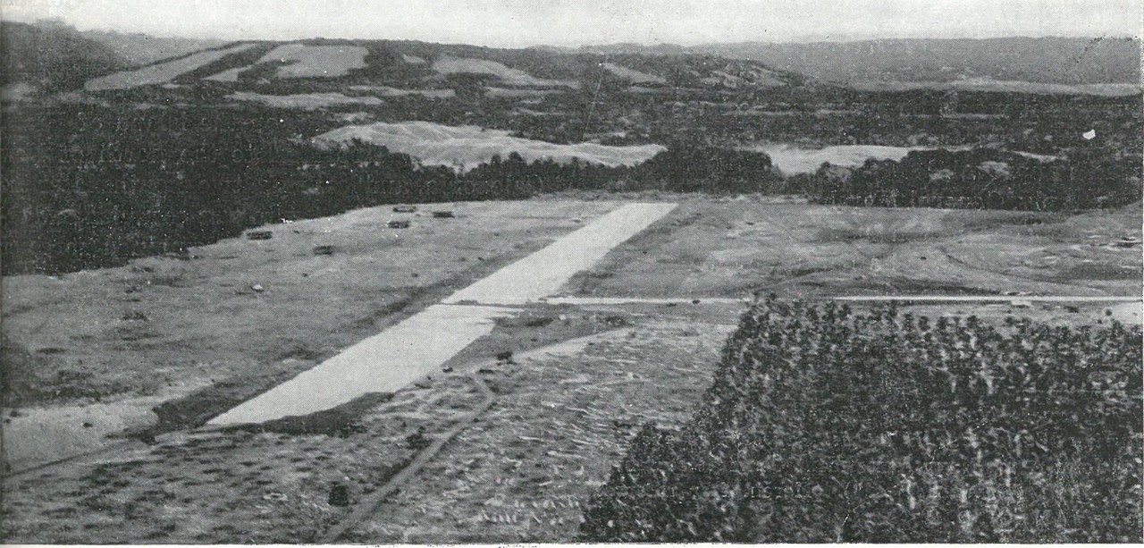 THE JAPANESE COMMENCED AN AIRSTRIP on Guadalcanal early in July. Between the jungle (left) and coconut groves (right) of Lunga Point extended the almost completed airfield which was to be renamed Henderson. Note Mt. Austen rising against the cent...