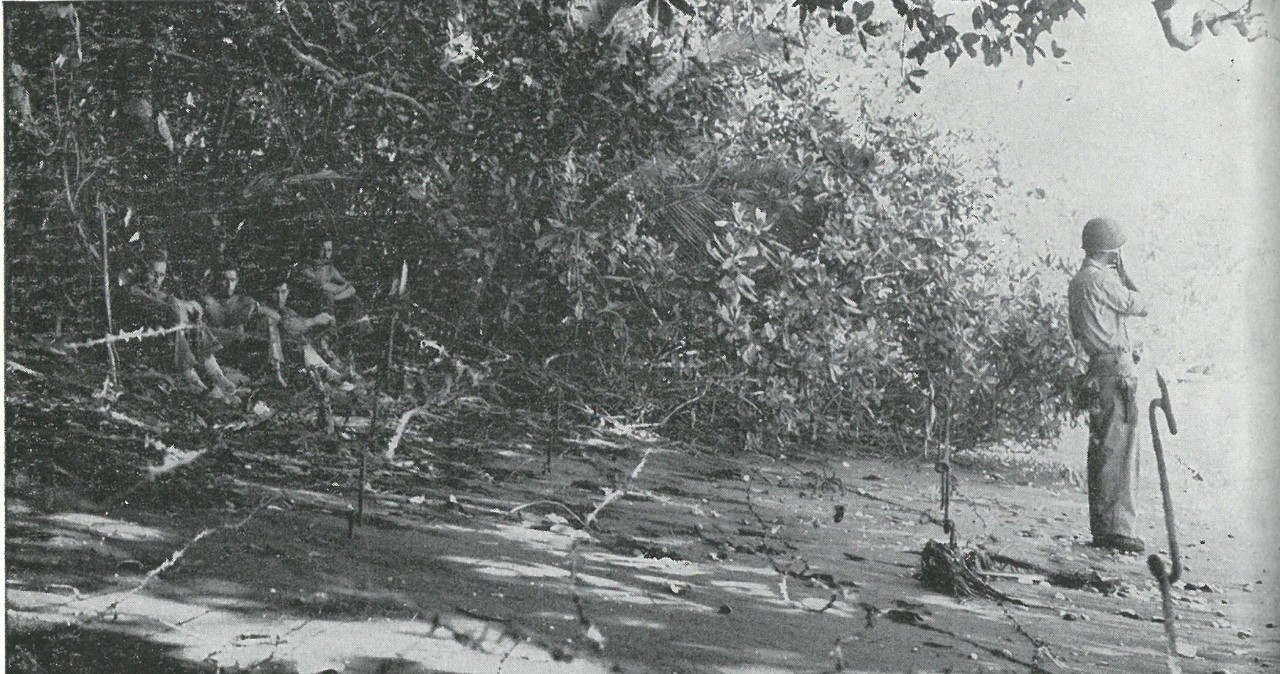 BEACH DEFENSES were hastily established with such meager materials as had been left by the retiring transports. Japanese counter-landing behind the Marine perimeter was a constant threat during early days of the campaign.