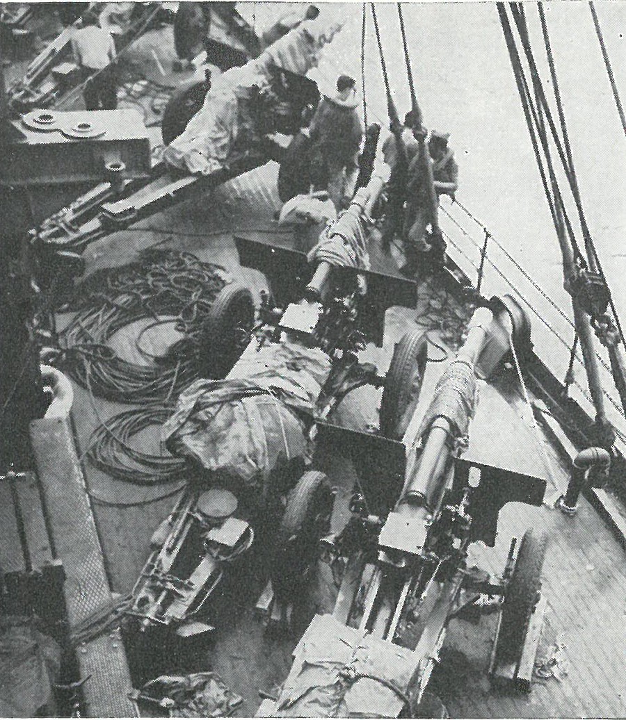 ENROUTE TO THE OBJECTIVE, 105mm howitzers of the 5th Battalion, 11th Marines are lashed on deck.