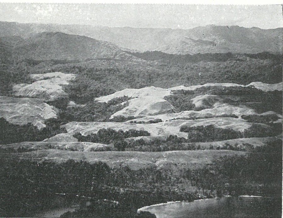 GUADALCANAL PRESENTS A VARIED TERRAIN: this view looking south over Point Cruz shows the jumble of sharp-grassed ridges, foothills and mountainous jungle which was Guadalcanal.