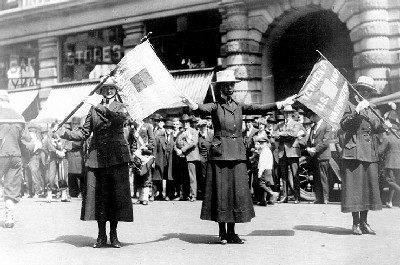 Yeomen (F) from Washington, D.C. Pose with their unit flags during a Victory Loan parade in New York City, May 1919
