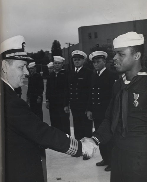 "Award of Purple Heart to William L. Parker, Steward's Mate Second Class, by Captain H. E. Schonland 'for wounds received in action against an enemy of the United States on 20 October 1944.'" 