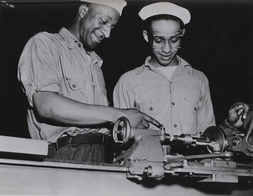 "Machinist mates school, Great Lakes, Illinois: cutting a pipe thread on a 9-inch lathe."