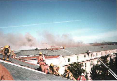 Firefighters battle the roof fire on the morning of 12 September 2001.