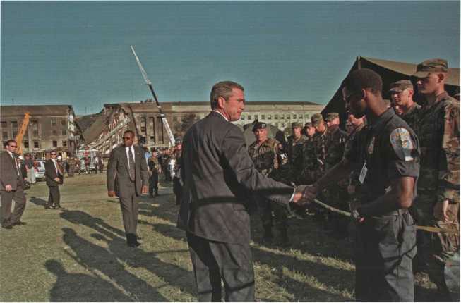 President Bush thanks responders while visiting the Pentagon crash site on 12 September 2001.