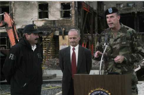 FBI representatives Arthur Eberhart and Van A. Harp (left) hand over management of the crash site to Major General James Jackson, Commander, U.S. Army Military District of Washington, 26 September 2001.
