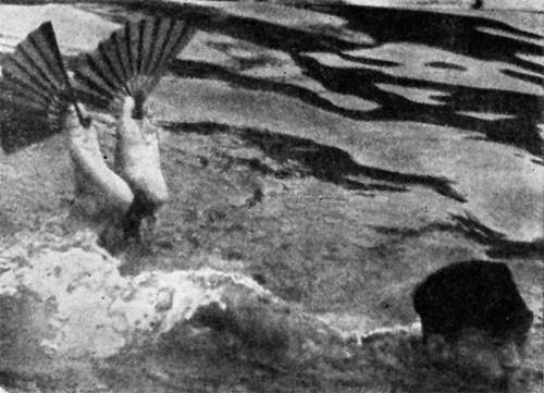But what we overlooked was this: The little man swimming with his feet out of the water was learning to carry military code messages between his toes "in front of the enemy stealthily."