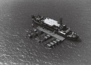 Self-propelled barracks ship USS Benewah (APB-35) with Armored Troop Carriers (ATC) tied up alongside pontoon. Benewah is at anchor in Vung Tau harbor as headquarters for River Assault Flotilla ONE, which operated in the Rung Sat Special Zone and the Mekong Delta.