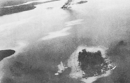 Image of 'Makambo Island under bombardment, Gavutu and Tanambogo in background.'