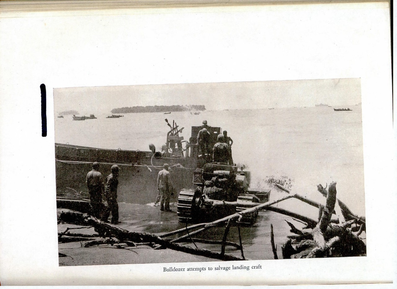 Bulldozer attempts to salvage landing craft