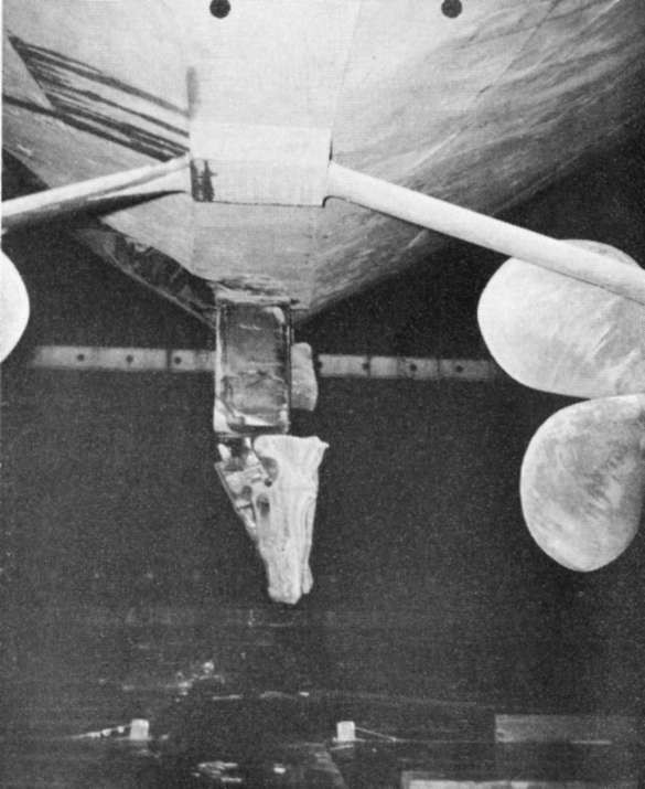 Photo 75: INTREPID (CV 11) Looking aft at damaged rudder and missing fairing piece.