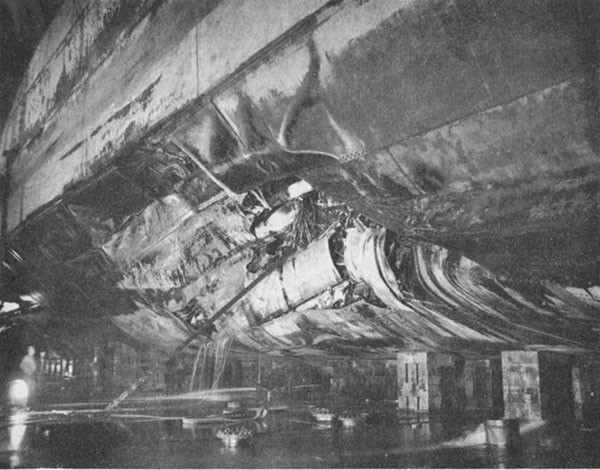 Photo 26: CANBERRA (CA 70) Looking aft at torpedo damage.