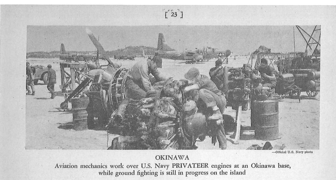 OKINAWA; Aviation mechanics work over U.S. Navy Privateer engines at an Okinawa base, while ground fighting is still in progress on the island