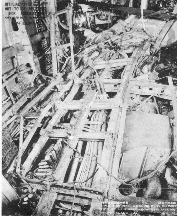 Photo 20: Interior view of forward engineroom, looking forward on port side, showing damage to main switchboard platform.