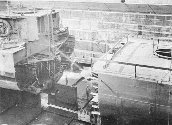 Photo 38: 7 October 1943 - ABNER READ in dry dock at Puget Sound Navy Yard showing temporary steering gear. Prefabricated stern section is in foreground.