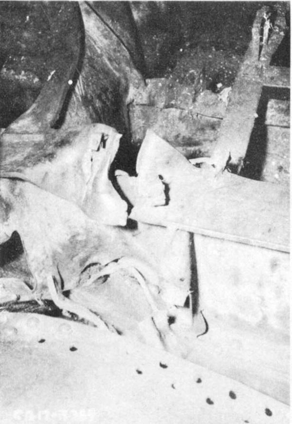 Photo 6: View of keel between frames 97 and 98 showing damage to flat keel, fracture of top flange and distortion and partial failure of vertical keel.