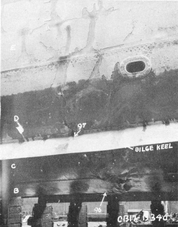Photo 7: Starboard side view of damage to shell. Note failures in "B", "C", and "D" strakes and buckles in "E" strake.
