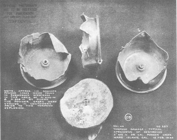 Photo 55: Typical specimens of damaged Mark V, 5-inch 38 caliber powder cases found in A-406-M and A-308-M.
