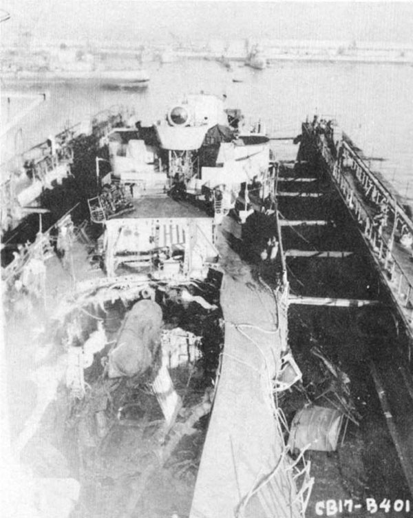 Photo 8: 9 February 1943 - General view of damage to forward engineroom, after fireroom and main deck after removal of No. 2 smokepipe and deck house.