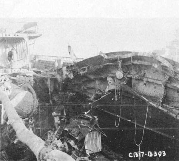 Photo 10: 9 February 1943 - View of damage to port-side main deck structure looking aft and to port.