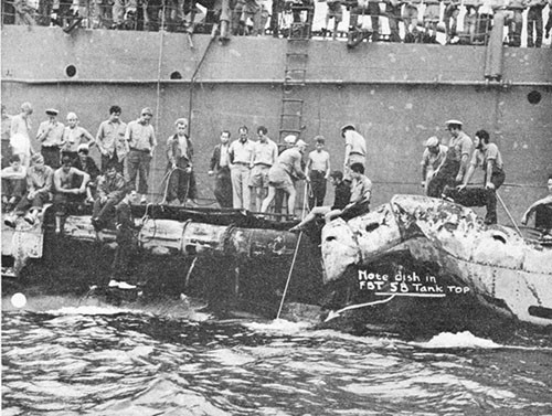 Photo 9-3: SCAMP (SS277). View from port side, showing bomb damage to superstructure. No structure has been removed yet.