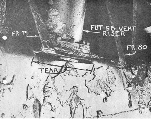 Photo 9-7: SCAMP (SS277). Close view, looking down at tank top of FBT No. 5B, showing two-foot longitudinal tear which occurred at a point of stress concentration in the knuckle between the tank top margin plate and outer hull.
