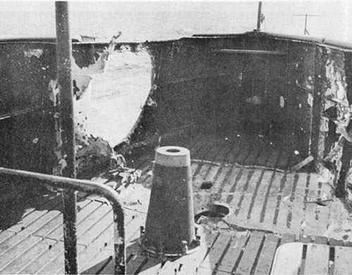 Photo 12-1: GRAMPUS (SS207). Projectile entry hole in starboard bulwark of cigarette deck.