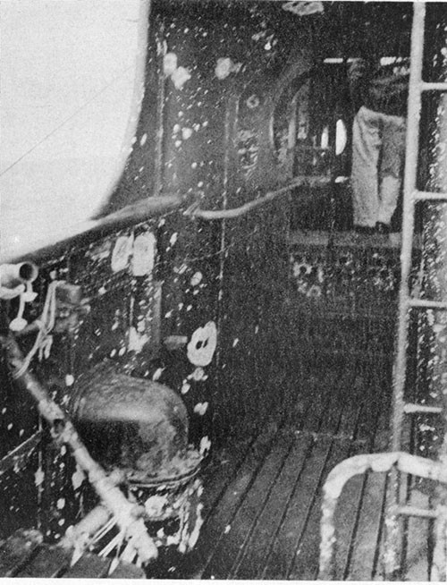 Photo 12-3: GRAMPUS (SS207). Fragmentation damage, port bulwark forward end of cigarette deck.